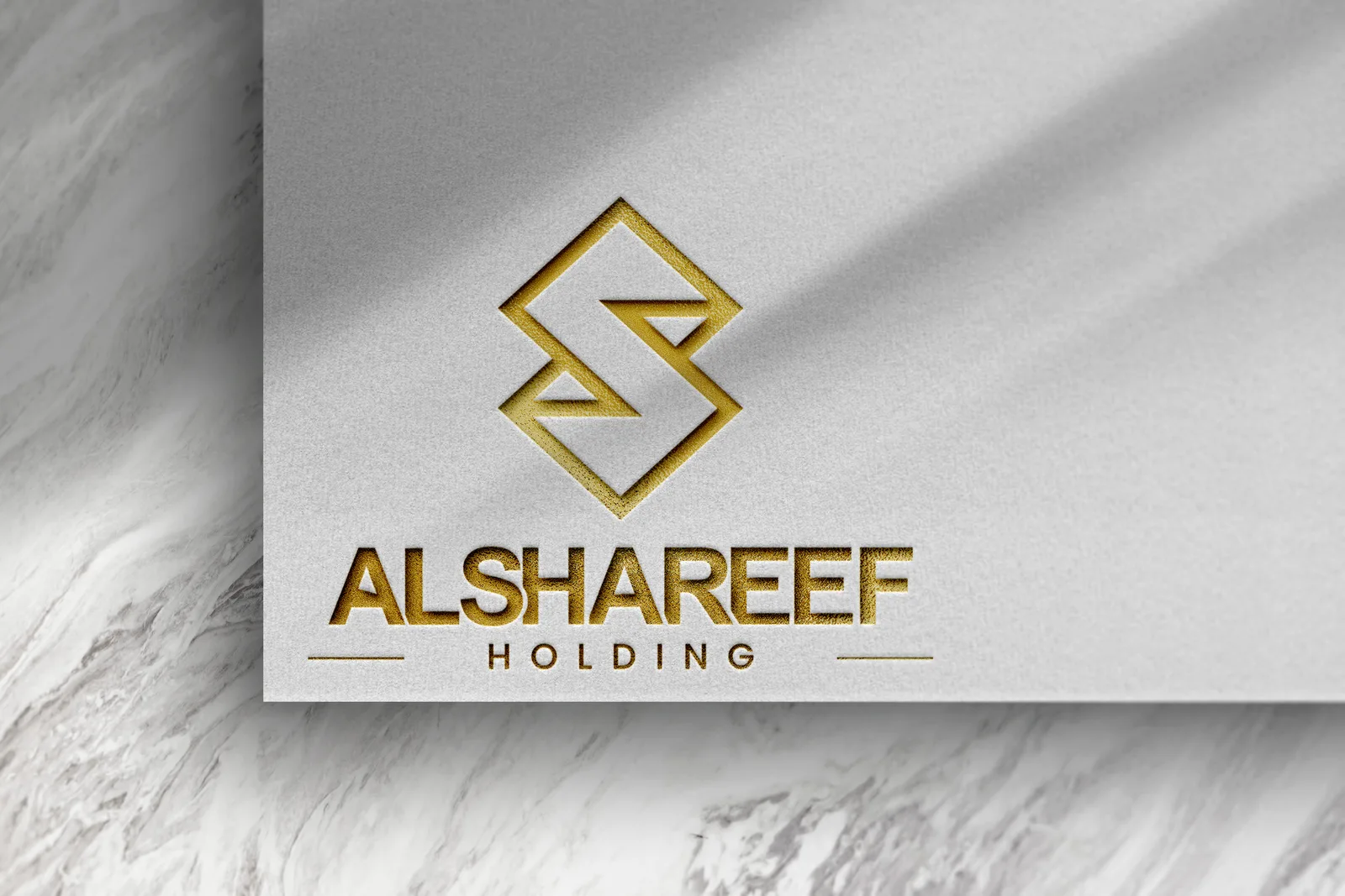 The chosen mark, gold on white stock, as it appears on the stationery.
