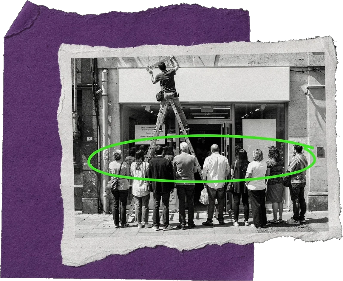 Black-and-white photo of a worker on a ladder fixing a blank sign above a shop door while a crowd of people stands in front of the door; the crowd is circled in green.