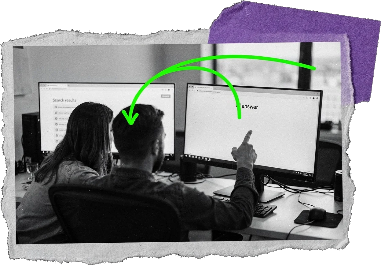 Black-and-white photo of two colleagues at two computer monitors showing search results; a green arrow curves from one screen to the other.