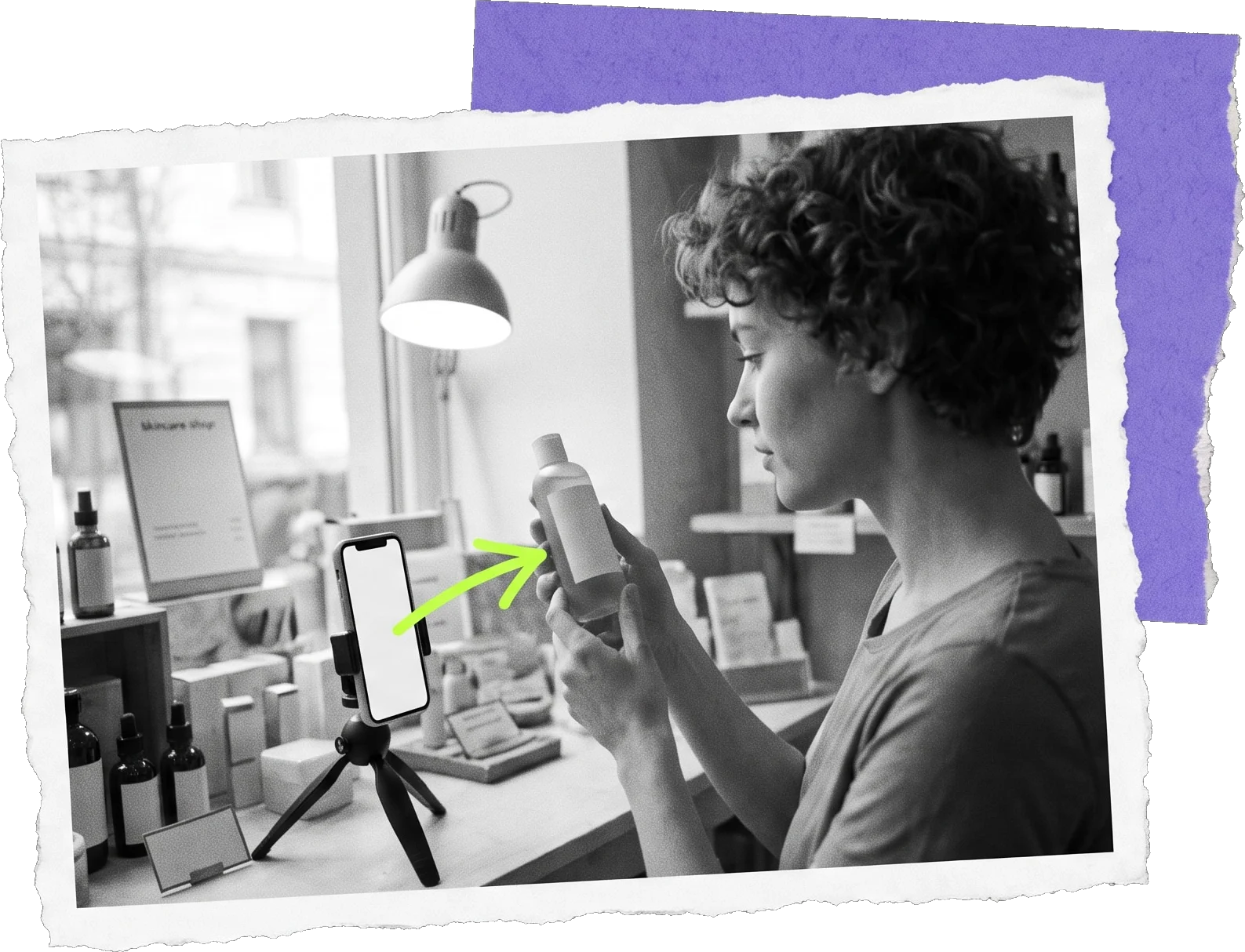 Black-and-white photo of a woman holding a bottle toward a phone on a tripod in a small studio; a green arrow points at the bottle.