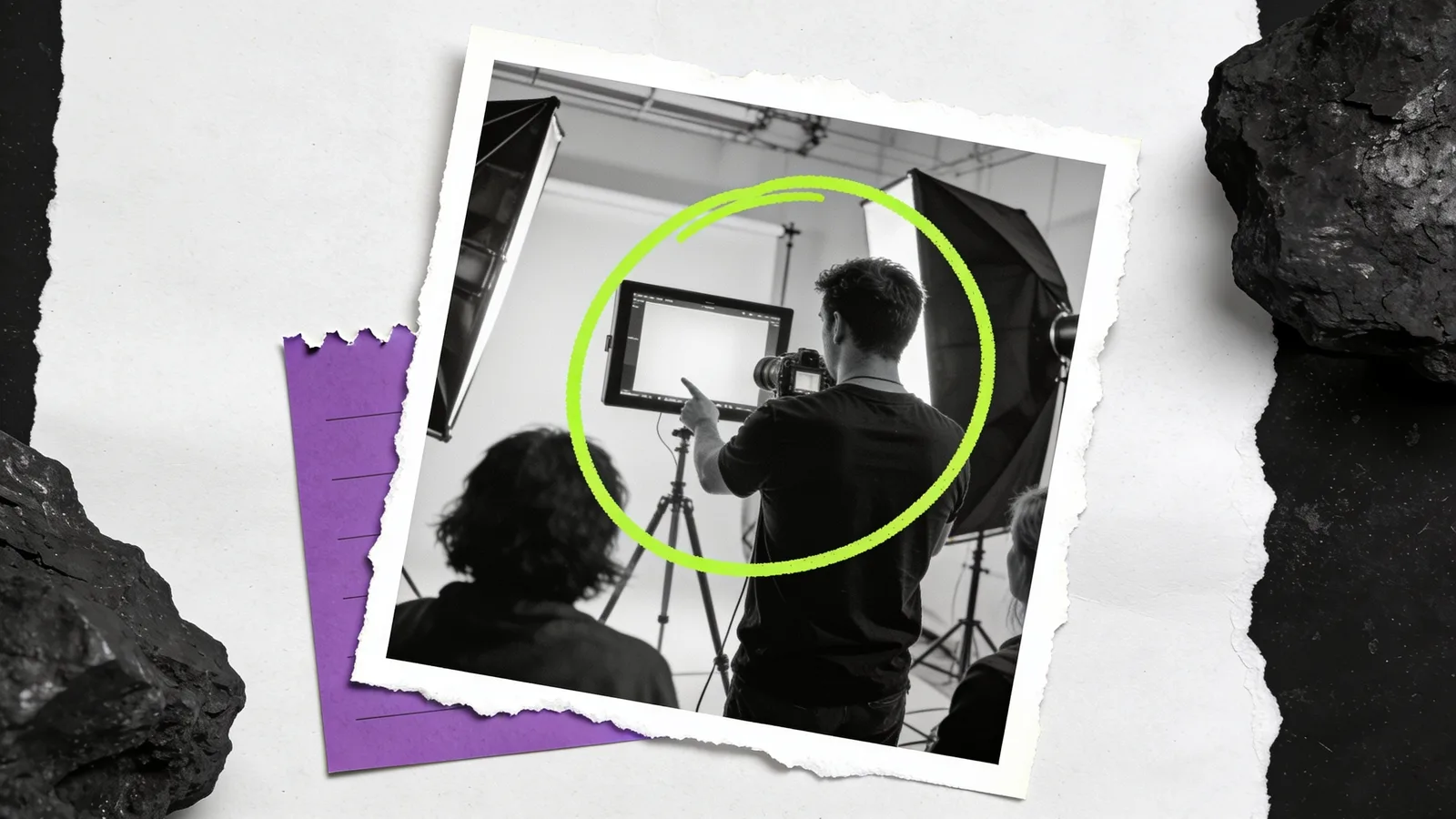 Black-and-white photo of a photographer pointing at a monitor in a studio with lights and a crew member, the monitor circled in green.